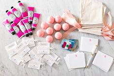 pink and white items laid out on a marble surface