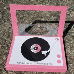 a pink record box sitting on the ground