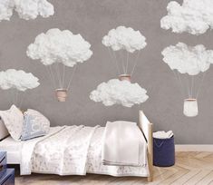 a bedroom with clouds and hot air balloons in the sky