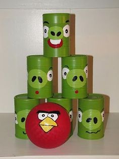 a stack of green cups with angry birds painted on them and one red ball in the middle