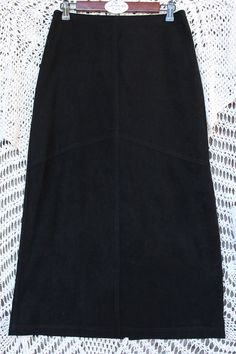 "Beautiful long black pencil skirt made in USA of polyester / spandex features a 6 1/2\" back zipper and 15\" back walking slit. Fabric has a soft luxurious velour feel and is in excellent vintage condition. Please see all photos as this is part of description. Perfect to wear with many different styles going for a casual, dressy or uniform look! Measurements are taken with garment lying flat. Waist to hemline: 33 1/2\" Waist: approx. 14 1/2\" Hemline: 22\" across Hips: 18 1/2\" across Slit: 15\"  Weight: 11.4 oz." Long Black Pencil Skirt, Uniform Skirt, Casual Dressy, Beautiful Belts, Black Pencil Skirt, Black Pencil, Long Black, Polyester Spandex, Different Styles