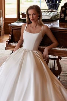 Turn heads in this luxurious Mikado satin ball gown adorned with pearls from neckline to train. Featuring a square neckline, Basque waist, and side pockets, this fairytale dress is perfect for unforgettable moments. #weddingdresses #ballgownweddingdress #weddingdress2025