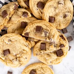 chocolate chip cookies are piled on top of each other