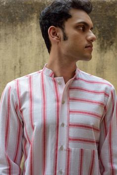 Description: A long-sleeve mandarin collared shirt with a mix of horizontal and vertical candy red stripes. Front button fastening and regular sleeve cuffs. Nice and easy.Colour: Red/WhiteFabric: Handwoven CottonProduct Details :100% CottonMade in IndiaGarment length S - 29"Garment length M - 29"Garment length L - 29.5"Garment length XL - 30"Size and Fit: Height: 6.2 ftModel is wearing size MFit: RegularProduct Care: Gentle hand wash separately with cold water. Mild liquid detergent. Do not soak