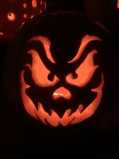 a carved pumpkin with an evil face on it