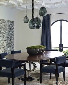 a dining room table with blue chairs around it