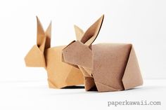 two origami rabbits made out of brown paper