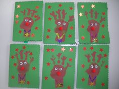 handprinted reindeer pictures on green paper with red nose and star decorations in the middle