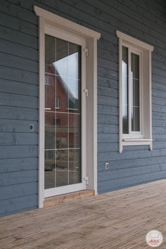 a house with blue siding and white windows