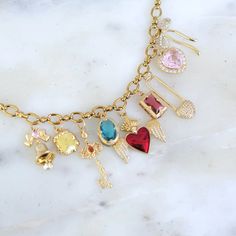 This beautiful gold charm bracelet features a variety of cute and intricate pendants, including hearts, keys, bows, and more. Perfect for anyone who loves adding a personal touch to their style, this bracelet blends elegance and playfulness. A must-have for those who appreciate unique, eye-catching jewelry. #Charms #Cute #GoldJewelry #HandmadeAccessories #BohoChic #JewelryTrends” Cute Pendants, Red Heart Necklace, Diy Charm Bracelet, Jewelry Charms, Gold Charm Bracelet, Gold Charm Necklace, Gold Charm, Handmade Accessories, Jewelry Trends