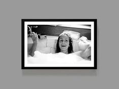 a woman laying in the bathtub with her feet up