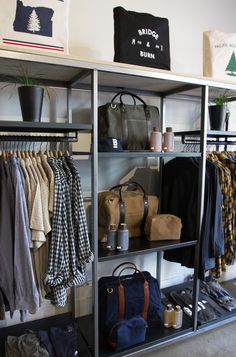 an organized closet with clothing and handbags