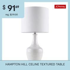 a white lamp sitting on top of a table next to a price label for $ 19 99