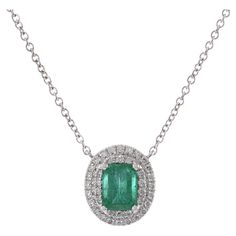 This elegant pendant features a 0.63 carat oval cut emerald, beautifully set in 18KT white gold. The pendant is accented with 0.28 carats of round cut diamonds, adding a touch of sparkle and sophistication. The combination of the vibrant emerald and shimmering diamonds creates a classic and timeless look. This pendant comes with a matching chain, making it perfect for adding a touch of luxury to any outfit. Elegant Pendant, Baguette Cut Diamond, Modern Necklaces, Emerald Stone, Emerald Diamond, Oval Diamond, Round Brilliant Cut Diamond, Round Cut Diamond, Brilliant Cut Diamond