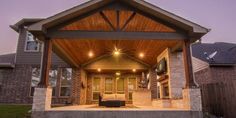 an outdoor covered patio with seating and lights