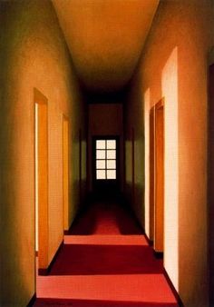 an empty hallway with red carpet and yellow doors