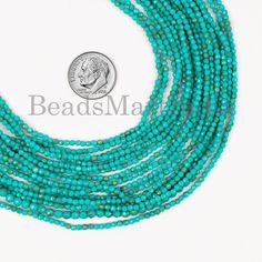 beads made with turquoise green glass beads on a white background, the beads are long and have