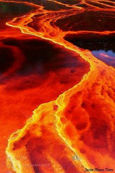 an aerial view of the earth's water and landforms, with bright orange colors