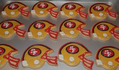 decorated cookies in the shape of helmets are ready to be baked for sports team fans