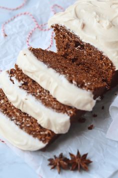 a piece of cake with white frosting and cinnamon sprinkles next to it