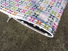 a colorful blanket sitting on top of a metal stand