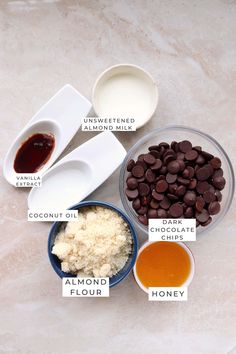 ingredients to make chocolate chip cookies laid out on a marble counter top with labels labeled