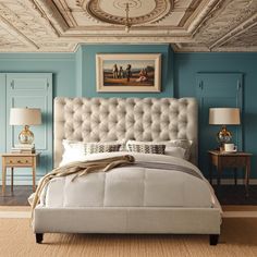 a bedroom with blue walls and white furniture