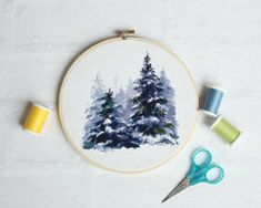 a cross stitch project with some scissors and thread