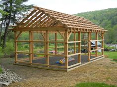 a small wooden structure in the middle of a field