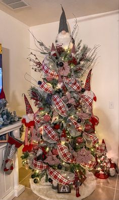 a christmas tree decorated with red, white and blue ribbons