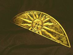 a gold brooch with the image of jesus on it's face is shown