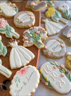 some decorated cookies on a table with wedding rings and other items in the shape of flowers