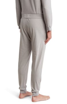 These soft-knit lounge joggers have a relaxed cut that tapers down to snug cuffs which keep the legs from bunching up when you bundle up under a blanket. 29" inseam; 10" leg opening; 12" front rise; 16" back rise (size Medium) Elastic/drawstring waist Side-seam pockets Banded hem cuffs 63% polyester, 34% cotton, 3% spandex Machine wash, tumble dry Imported Men's Clothing Casual Solid Color Bottoms With Soft Touch, Comfort Stretch Sweatpants With Comfort Waistband, Comfort Stretch Sweatpants With Comfort Waistband For Relaxation, Comfortable Super Soft Bottoms For Leisure, Super Soft Comfortable Bottoms For Leisure, Comfortable Relaxed Fit Sweatpants For Sleep, Relaxed Fit Lounging Bottoms With Soft Touch, Relaxed Fit Bottoms For Lounging With Soft Touch, Comfortable Loungewear Pants With Elastic Cuffs