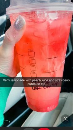 a person holding up a pink drink in their hand with the caption'veni lemonade with peach juice and strawberries, puree on top