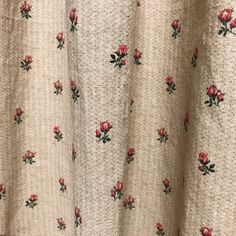 a close up view of the fabric with roses on it