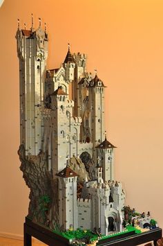 a lego castle made to look like it's on top of a table in front of a wall