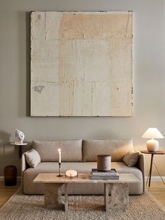 a living room with a couch, coffee table and two lamps on the side tables