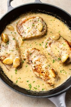 chicken with potatoes and gravy in a skillet on the counter top, ready to be eaten