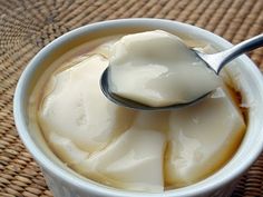 a spoon full of ice cream sitting in a bowl