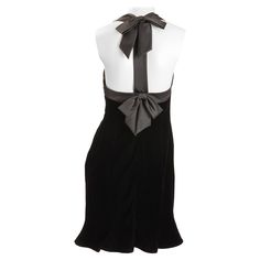 Nipon Boutique black velvet cocktail dress with satin ribbon trim and bows tied at neck and back. Flirty six paneled dress body with flared bottom. Fully lined. Size US 6 Labeled, Nipon Boutique 65% Acetate 35% rayon velvet . Elegant Mini Dress With Bow For Black-tie Events, Elegant Knee-length Velvet Dress For Formal Occasions, Elegant Velvet Mini Dress For Holidays, Formal Holiday Dress With Bow, Elegant Sleeveless Dress With Ribbon Detail, Elegant Velvet Cocktail Dress For Holiday, Elegant Black Velvet Holiday Dress, Elegant Knee-length Velvet Mini Dress, Chic Fitted Dress With Ribbon