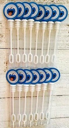 six blue and white toothbrushes are lined up on a wooden wall with holes in them