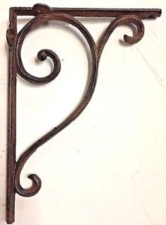 an old iron shelf bracket on a white wall