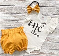 "Bee 1st birthday outfit It's my 1st Bee Day! Such a cute outfit to make your little one's big day extra special! This trendy high waisted bummie short and bodysuit set are sure to be a huge hit on your little one's big day! You may choose: ~Flutter sleeve bodysuit as shown. \"One\" with bee design. ~Adorable high waisted bummie shorts as shown. ~Darling matching fabric bow/headband as shown. At time of purchase please make note in the \"note to seller section\" the following info. ~event date C 1st Bee Day, Bee 1st Birthday, Smash Cake Outfit, Cake Outfit, First Birthday Tutu, 1st Birthday Outfit, Birthday Tutu Outfit, Birthday Girl Outfit