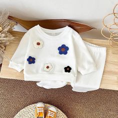 Cuddle up in comfort and style with our adorable Flower Print Sweatshirt & Pants Set! 🌸 This unisex outfit is perfect for your little one this autumn. 🍂 Made from soft, breathable cotton, it features a cozy pullover sweatshirt with a playful flower print and matching pants for a complete look. The easy pull-over style makes dressing a breeze, while the relaxed fit allows for all-day comfort. 🤸‍♀️ Available in sizes for babies from 6 to 36 months, this baby boy clothes and baby girl clothes se Cozy Playtime Sets For Fall, Cozy Cotton Sets For Fall, Cozy Long Sleeve Cotton Sets, Cute White Sets For Fall, White Loungewear Set For Fall, White Sets For Loungewear In Fall, White Fall Loungewear Sets, White Long Sleeve Playwear Sets, Unisex Clothes