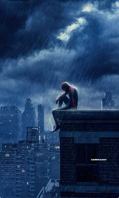 a man sitting on top of a building in the rain