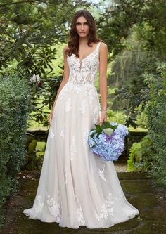 a woman in a wedding dress holding a bouquet