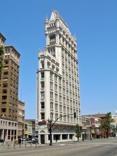 a tall white building sitting on the side of a road