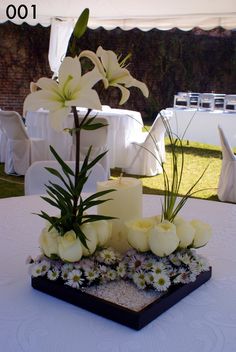 flowers and candles on a table at a wedding