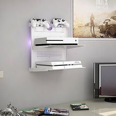 two video game controllers mounted to the side of a wall next to a computer monitor