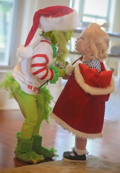 two children dressed in costumes standing next to each other